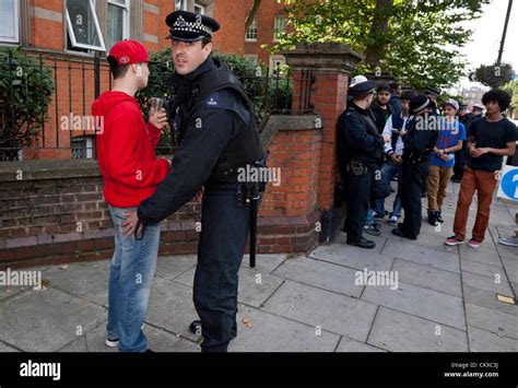 A Group Of Metropolitan Police Officers Stop And Search A Group Of Youths At The Notting Hill