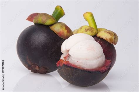 Mangosteen Fruit And Cross Section Showing The Thick Purple Skin And