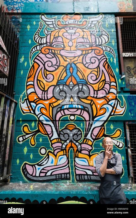 Australia Victoria Melbourne Man Smoking In Front Of Graffiti Of