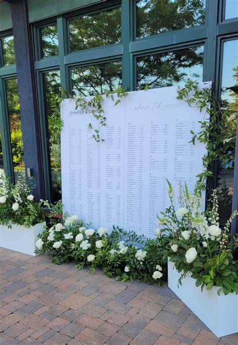 Large White Seating Chart For Guests With White Florals And