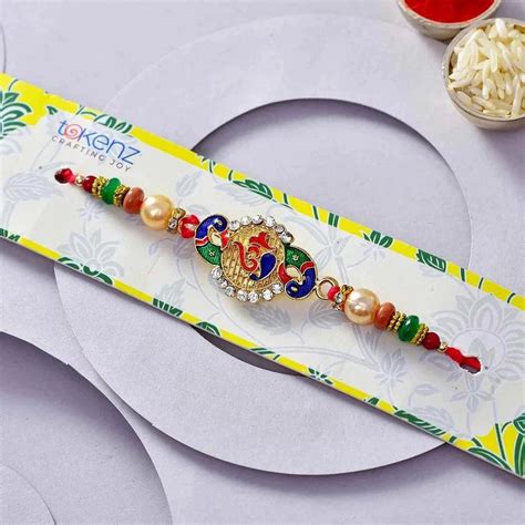 Tokenz KC786193 Awesome Om Peacock Meena Work Pearls Rakhi At Rs 432