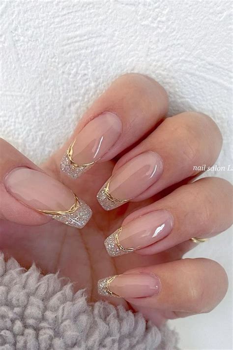 A Woman S Hand With French Manies And Gold Glitters On The Tips