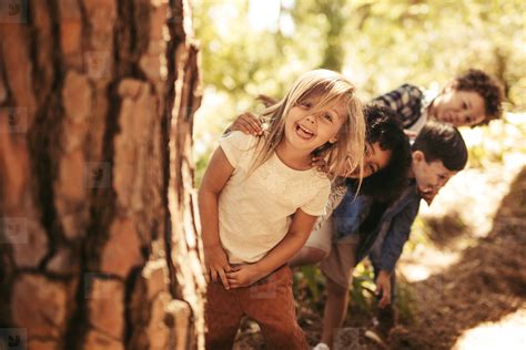 Kids playing hide and seek in a park stock photo (173615) - YouWorkForThem