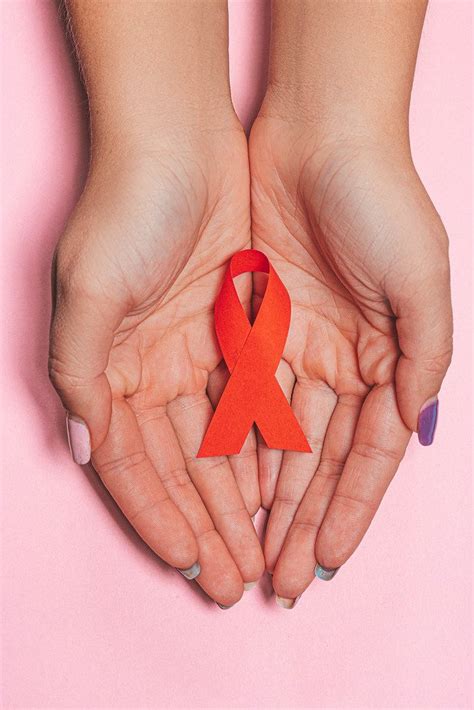 Healthcare And Medicine Concept Female Hands With Red AIDS Awareness