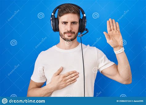 Hispanic Man With Beard Listening To Music Wearing Headphones Swearing