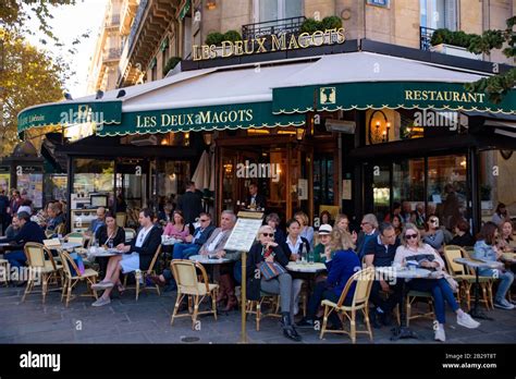 People Having Coffee At Outdoor Seating Of Les Deux Magots A Famous