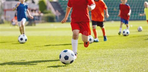 Kids Soccer Training Camp Kids Practicing Football On Grass Field