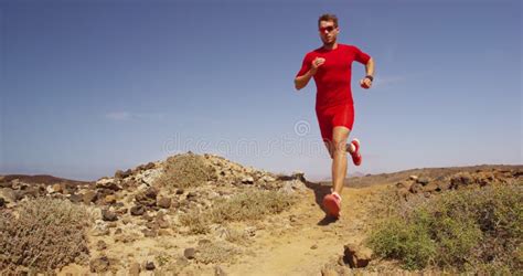 Male Athlete Is Running Towards An Obstacle Hurdling Jumping Over The