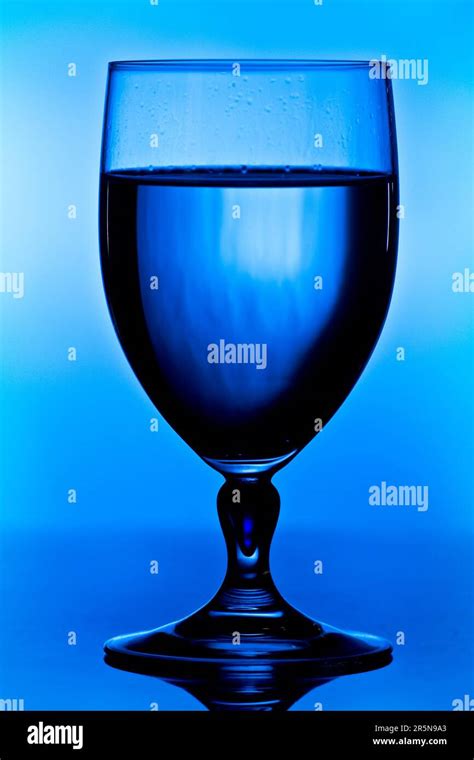 glass water  front  blue background  strong contrast