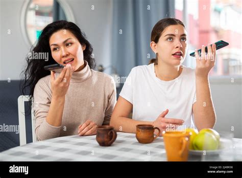 Women With Smartphones Recording Voice Messages At Home Stock Photo Alamy