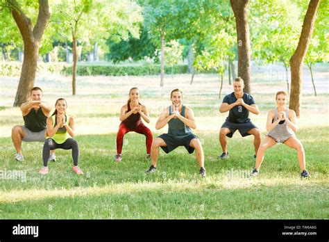 Group Of Young People Doing Exercise Outdoors Stock Photo Alamy