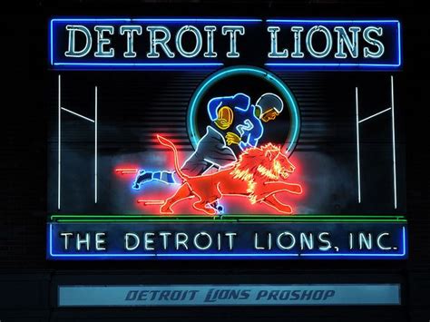 Detroit Lions Neon Sign On The Side Of A Building At Night With An