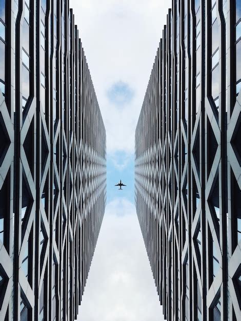 Premium Photo Directly Below Shot Of Airplane Flying Over Buildings