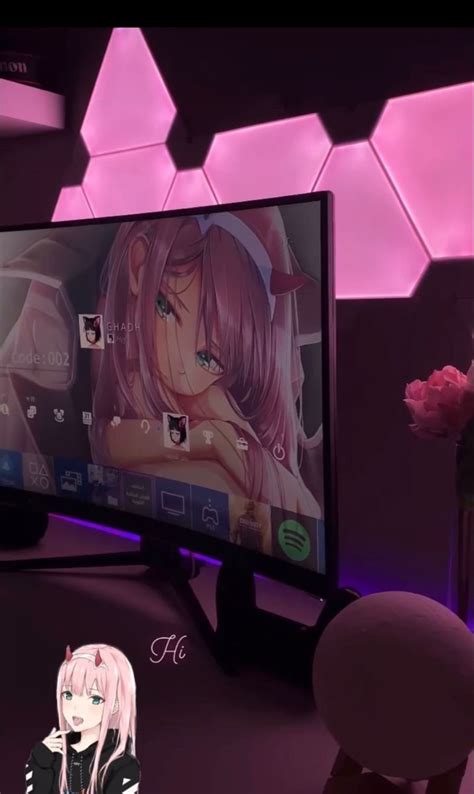 A Girl Is Sitting In Front Of A Large Screen Tv With Anime Characters On It