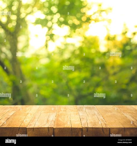 Empty Wood Table Top On Blur Abstract Garden And House Background For