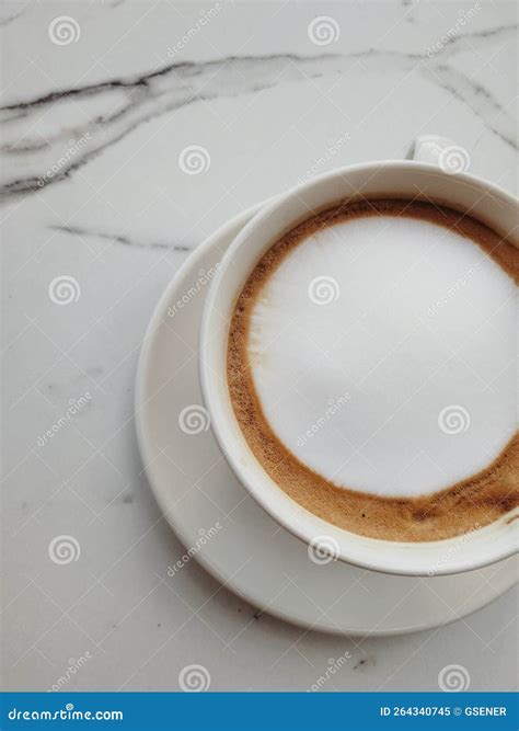 Top View Coffe with Silky Milk Foam on White Marble Patterned Table