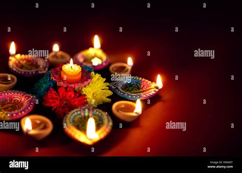 Diwali Oil Lamp - Colorful clay diya lamps with flowers Stock Photo - Alamy