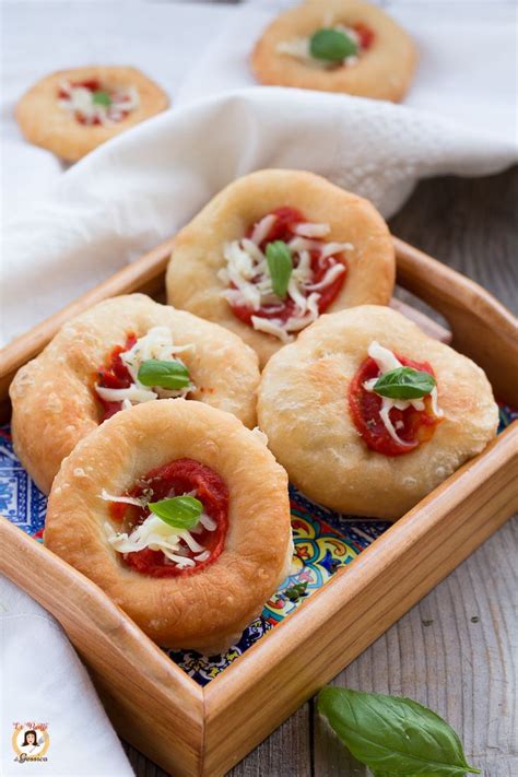 Small Appetizers With Cheese And Tomato Sauce In A Wooden Tray On A Table