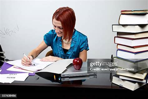 teacher grading papers   premium high res pictures getty images