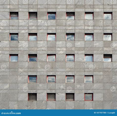 Gray Stone Modern Facade Of An Office Building With Windows Reflecting