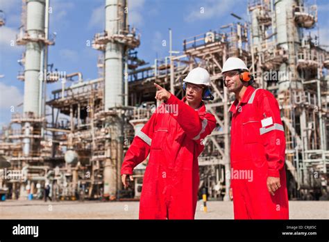 Workers Talking At Oil Refinery Stock Photo Alamy