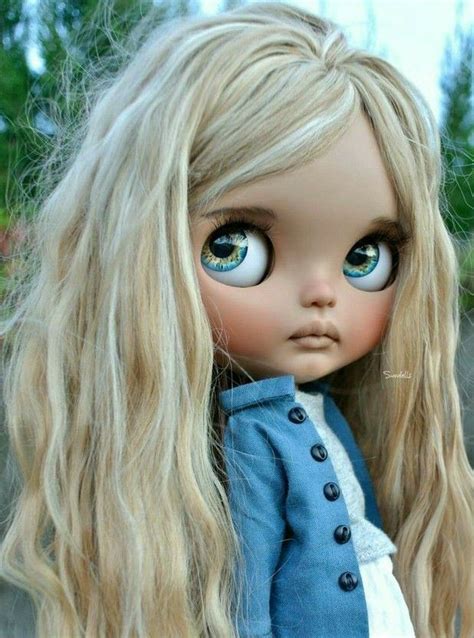 A Doll With Long Blonde Hair And Blue Eyes