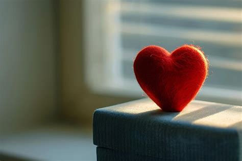 Premium Photo A Red Heart Sitting On Top Of A Box In The Style Of Realism