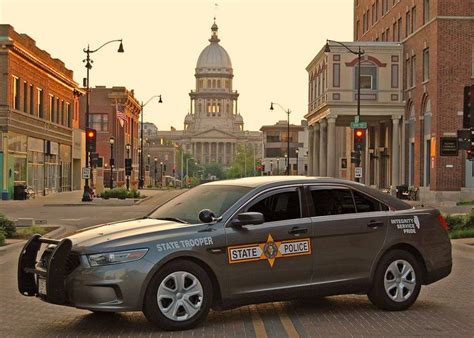 a police car is parked on the side of the road in front of some buildings