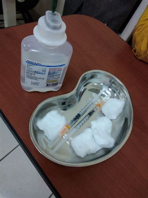 A Heart Shaped Tin With Cotton Floss In It And A Bottle Of Medicine