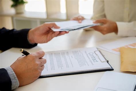 Premium Photo Cropped Image Of Business People Holding Documents At Table