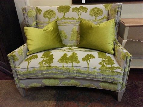 A Green And White Chair With Pillows On It