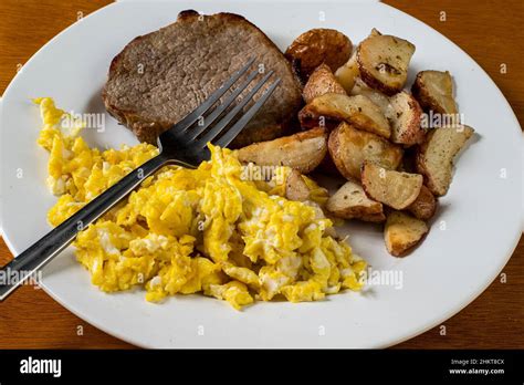 Steak Served With Scrambled Eggs And Home Fries Stock Photo Alamy