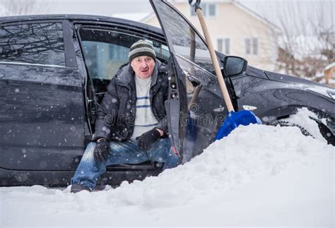 A Man Cleans Snow With A Shovel Near The Garage Stock Photo Image Of