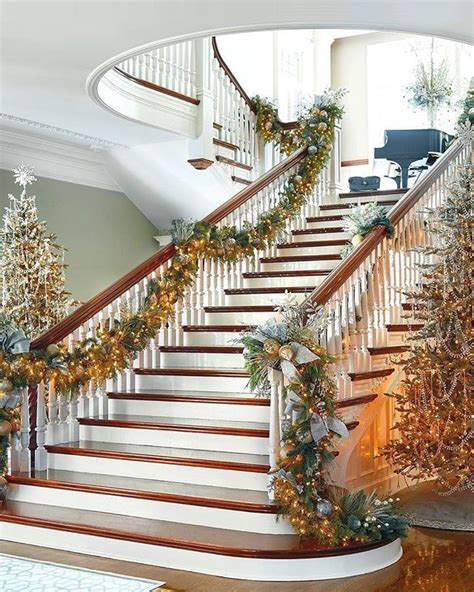 a staircase decorated with christmas trees and garland