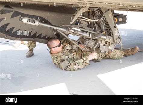 A U S Army AH 64E Apache Helicopter Ground Crew Member Assigned To