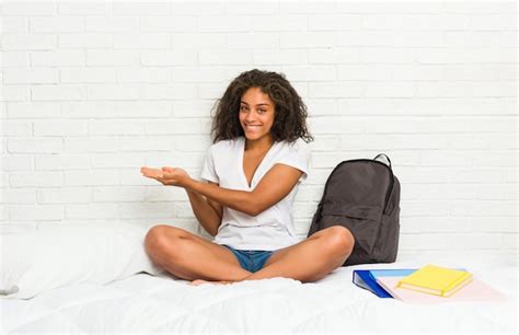 Premium Photo Young African American Student Woman On The Bed Holding