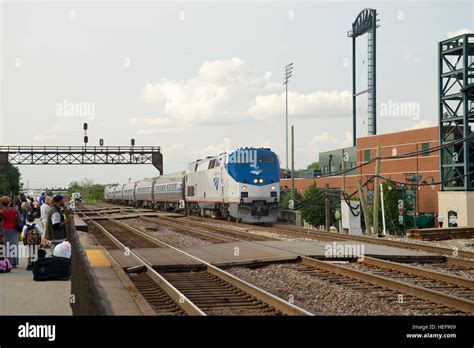 Amtrak train at Joliet Union Station, Joliet, Illinois, USA, with Silver Cross Field in ...