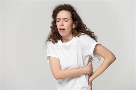 Unhealthy Young Woman Suffering from Strong Back Strain. Stock Image ...