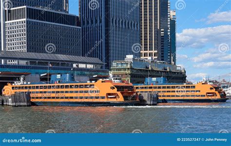 Two Orange Staten Island Ferry Boats In The Slips At The Ferry Terminal