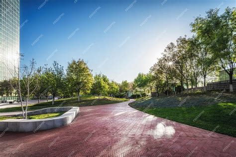 Premium Photo Peaceful Urban Park With Curved Pathway And City View