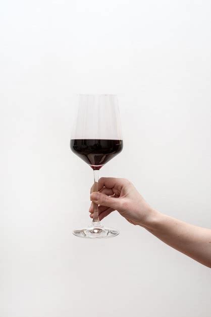 Premium Photo Hand Hold Red Wine Glass