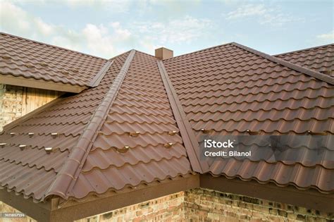 Detail Of House Roof Structure Covered With Brown Metal Tile Sheets