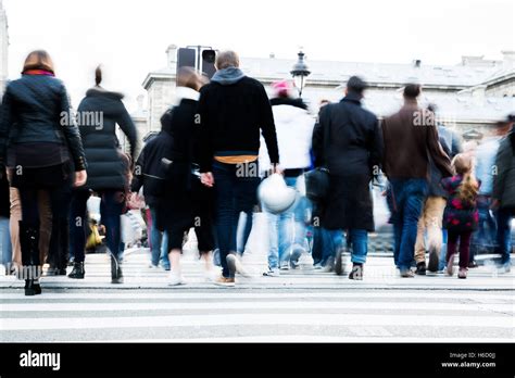 Picture With Motion Blur Of A Crowd Of People Crossing A City Street At