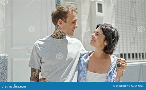 Beautiful Couple Hugging Each Other Holding Key Of New Home At Street