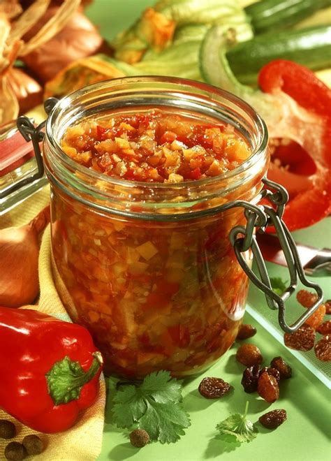 A Jar Filled With Lots Of Food Sitting On Top Of A Green Counter Next