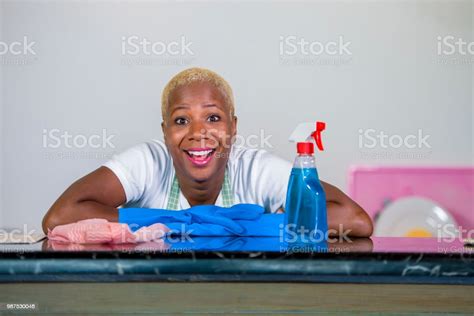 Young Beautiful And Happy African American Black Woman In Washing Rubber Clothes Cleaning Home