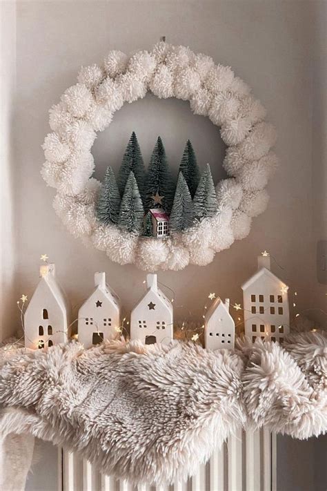 A White Fireplace Mantle Decorated With Christmas Decorations And