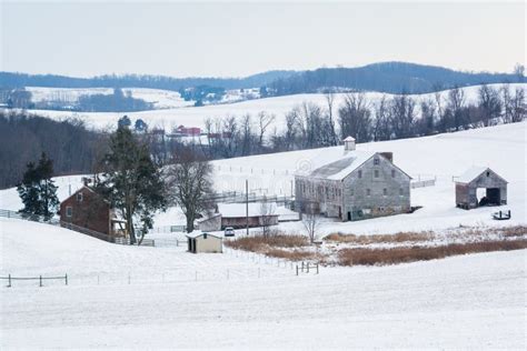 View Of A Snow Covered Farm And Rolling Hills Near Shrewsbury Stock