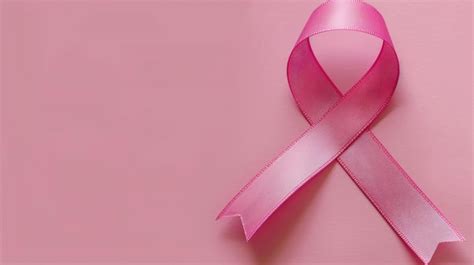 Premium Photo | Pink breast cancer awareness ribbon on a light pink ...