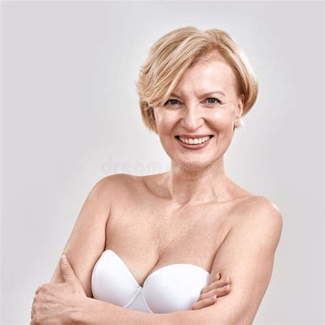 Portrait Of Beautiful Middle Aged Woman In White Bra Smiling At Camera